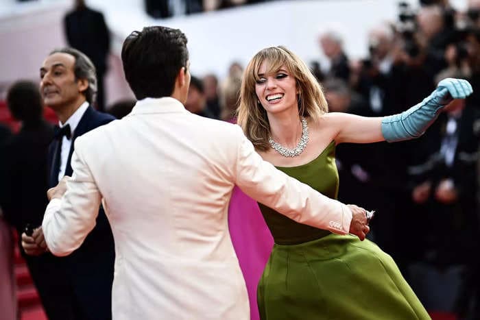 Maya Hawke danced down the Cannes red carpet in a colorful Prada gown with British actor Rupert Friend