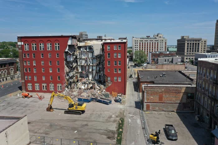 An Iowa city put the demolition of a collapsed apartment building on hold after finding another survivor. Protesters say people are still trapped inside.