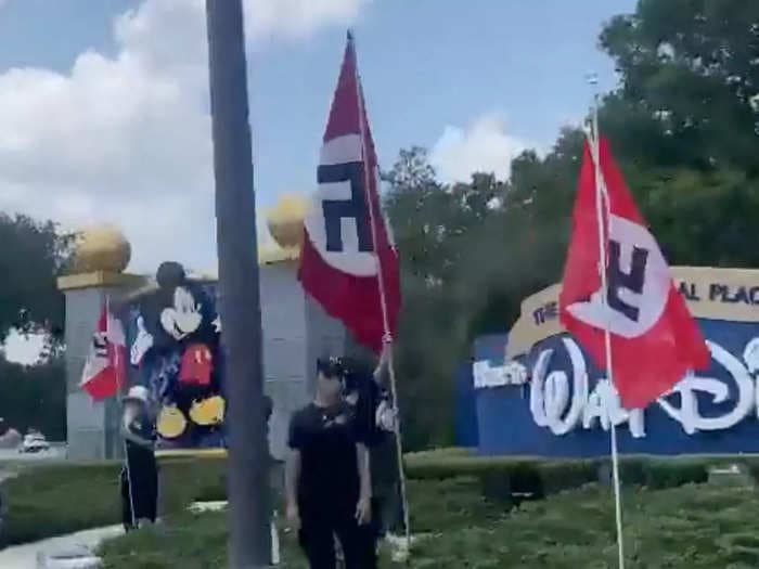 Protesters carrying Nazi flags and DeSantis imagery gathered outside Disney World in Orlando, Florida