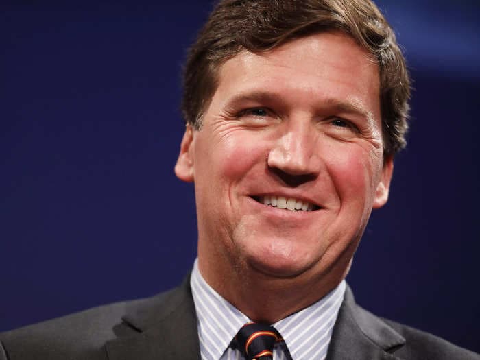 Tucker Carlson takes a shot at Fox News for backpedaling on chyron text labeling Biden a 'wannabe dictator'