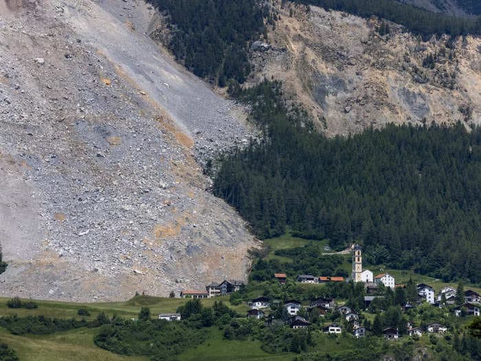 Images show how a Swiss Alps village narrowly escaped being wiped out by a massive rockslide that missed 'by a hair'