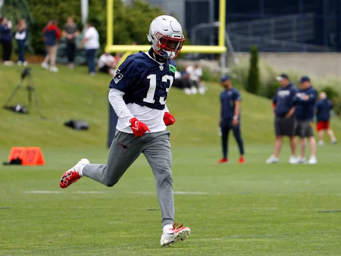 Police arrested a New England Patriots player at Boston's Logan Airport after they found two guns in his carry-on luggage