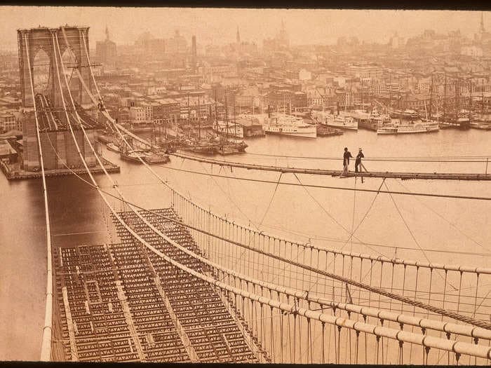 How the Brooklyn Bridge went from being a 'wild experiment' in architecture to becoming designated a historical landmark 140 years later