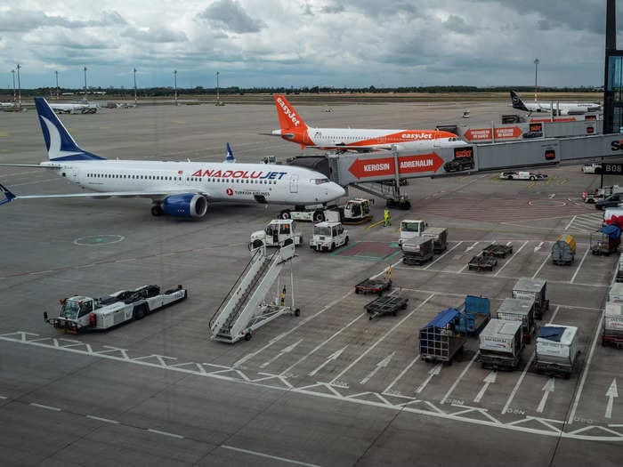 Passengers who missed their flight were arrested after they forced their way onto the boarding bridge and one jumped down onto the runway, says report