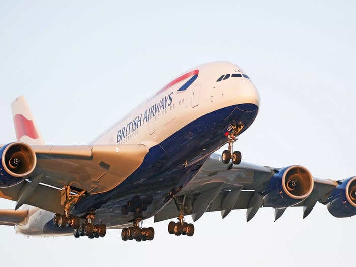 A superjumbo with 429 passengers turned back just after takeoff when the crew became 'dizzy and nauseous' from a 'burning smell' in the cabin
