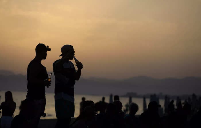 A video appearing to show a tourist defecating on a sleeping man's face sparks outrage on a Spanish island