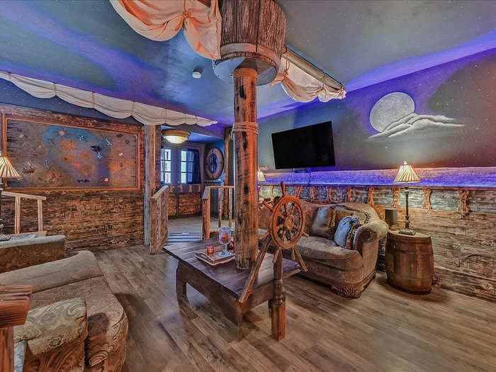 This "Pirates of the Caribbean"-inspired home has a mast and sail in the living room and ceilings painted like the night sky &mdash; see inside