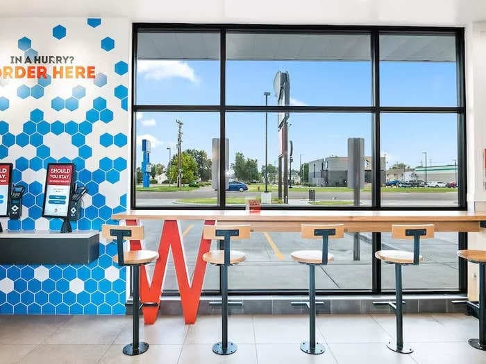 Take a look inside Wendy's tech-focused new-look restaurants. To collect a mobile order you park in a dedicated spot and collect your food from a pickup shelf.