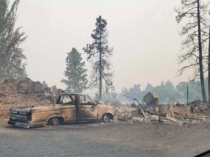 Photos taken by a firefighter show a scorched landscape filled with smoke in parts of a Washington town destroyed by wildfires