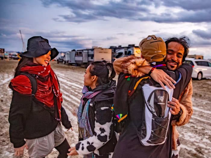 I'm a 12-year veteran of Burning Man. These 12 photos show a resilient community rallying around the rain and mud with joy and humor.