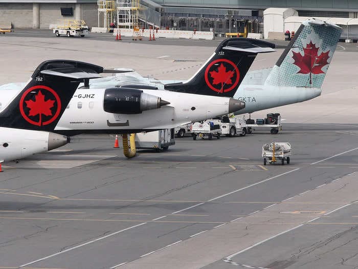 Air Canada apologizes after 2 passengers were kicked off a plane for refusing to sit in a vomit-covered seat