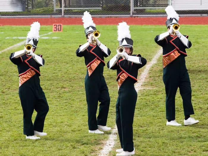 A high school band director was tased by cops at a football game after he refused orders to stop his musicians from playing