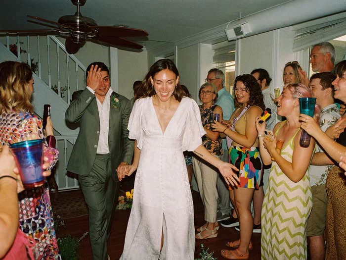 A woman turned her housewarming party into a surprise wedding in her living room. She said the lowkey affair was 'magical.'