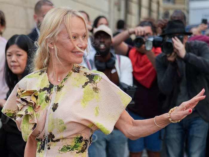 Pamela Anderson has got better stuff to do than sit around in a makeup chair — especially at Paris Fashion Week