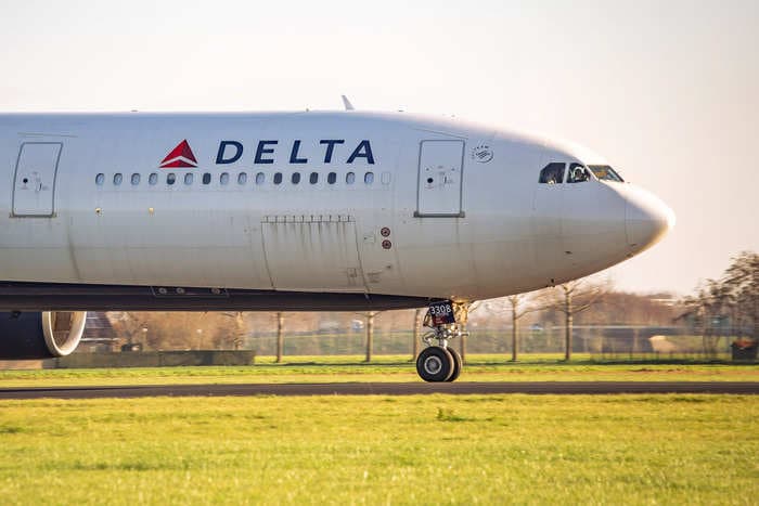 A former Delta copilot is accused of threatening to shoot the captain 'multiple times' if he diverted the plane due to a passenger's medical emergency