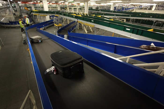 See the moment airport workers rescued a child from the baggage conveyor belt after he wandered past a check-in desk and into a restricted area