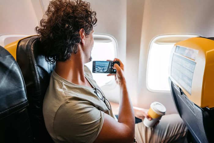 You're sitting next to someone in a window seat on the plane. Is it ever appropriate to take a photo over their shoulder? 