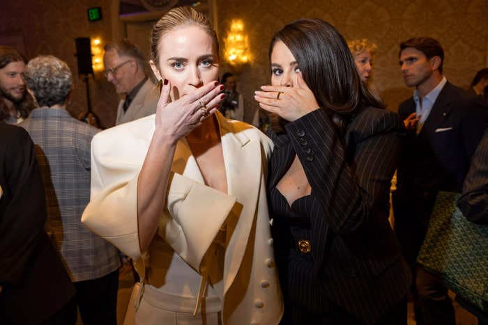 Selena Gomez and Emily Blunt cover their mouths as they pose together at the AFI Awards after viral lip-reading rumors