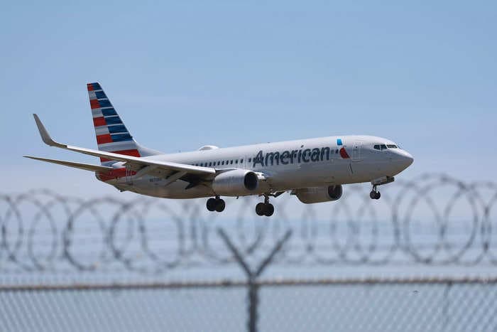An American Airlines flight attendant was charged over claims he photographed minors in airplane bathrooms 