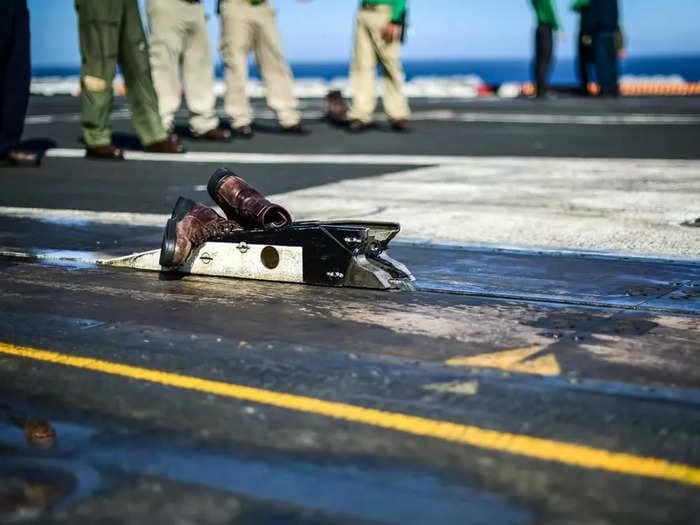 Here's why it's an aircraft carrier tradition to catapult a pair of boots