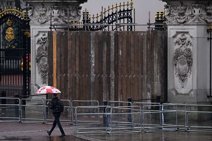 Buckingham Palace's gates are boarded up after someone crashed a car into them, police say