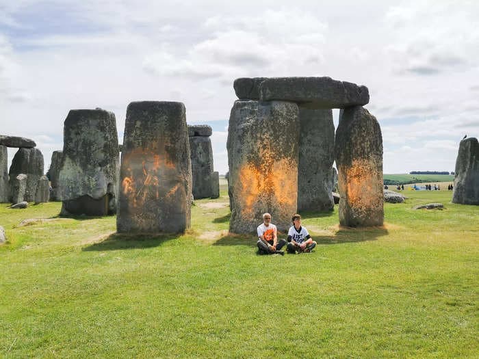 Two climate protesters spray Stonehenge with orange paint and call for an end to burning fossil fuels