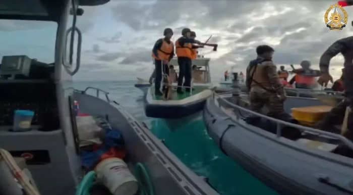 Video shows Chinese coast guard brandishing an ax in a low-tech clash with the Philippines navy