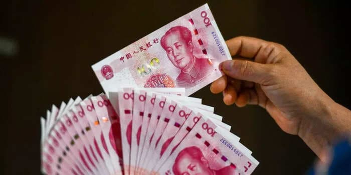 China's yuan is tumbling amid US sanctions and as central banks boost dollar holdings
