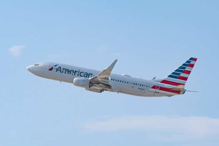 An American Airlines passenger is suing, saying she was burned by a coffee pot that fell into her lap from a trolley during turbulence