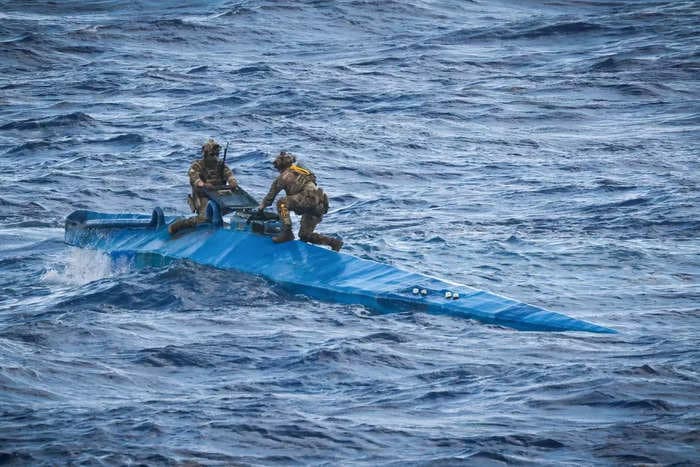 Newly released photos capture British commandos and American forces hunting down a narco-sub carrying $209 million of cocaine in the Caribbean