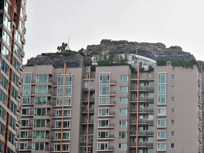 Chinese Man Who Spent Six Years Building A 'Mountain Villa' On Apartment Roof Ordered To Tear It Down