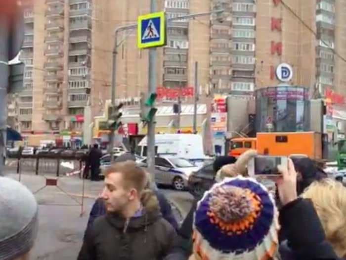 REPORT: A woman dressed in black is walking near a Moscow metro station holding a severed head