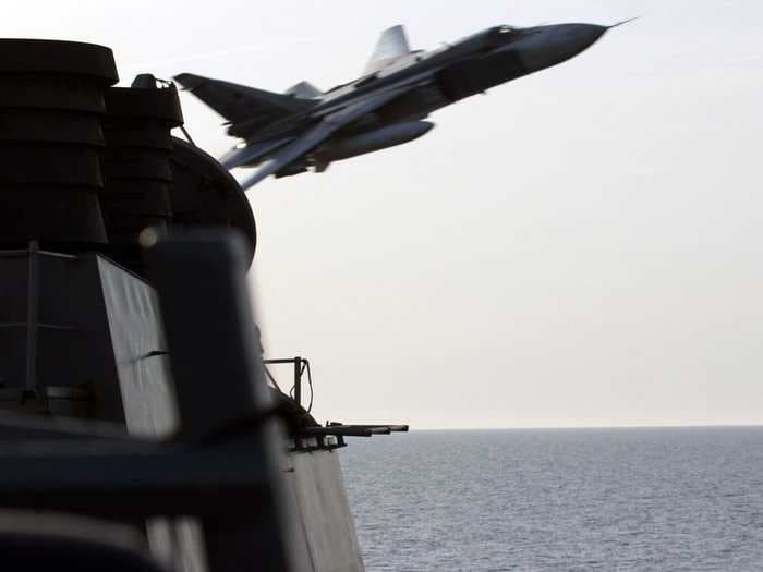 Watch Russian warplanes fly dangerously close by a US Navy ship