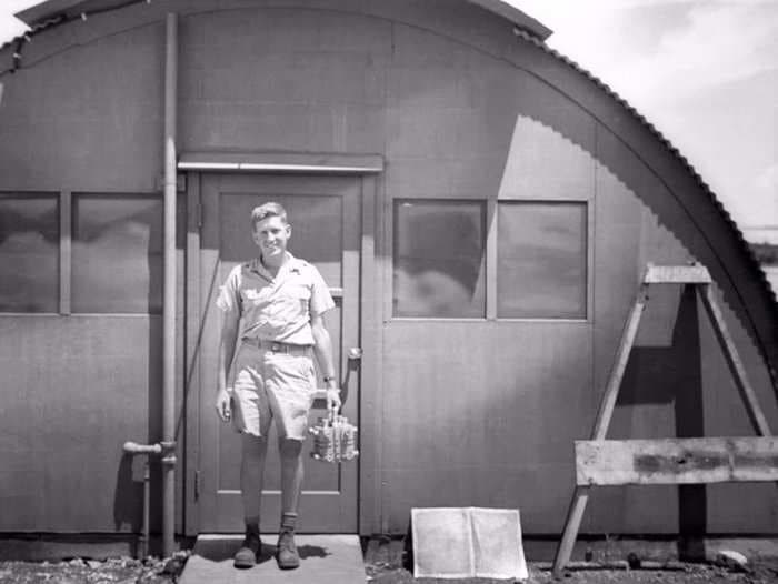 An unsettling photo of a US physicist cheerfully holding the 'Fat Man' atomic bomb's core