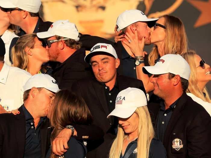 A fantastic photo of golfer Rickie Fowler celebrating by himself in the midst of couples after USA won the Ryder Cup