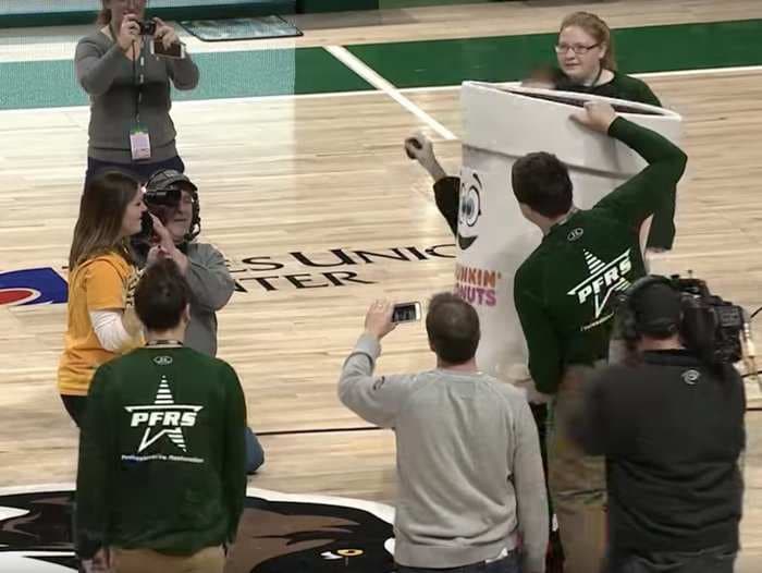 Woman hits half court shot to win $500, then gets a surprise marriage proposal from her boyfriend hiding in a Dunkin' Donuts costume