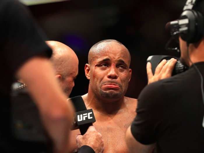 The UFC is under fire after Daniel Cormier was kept in the octagon for a post-fight interview shortly after being knocked out
