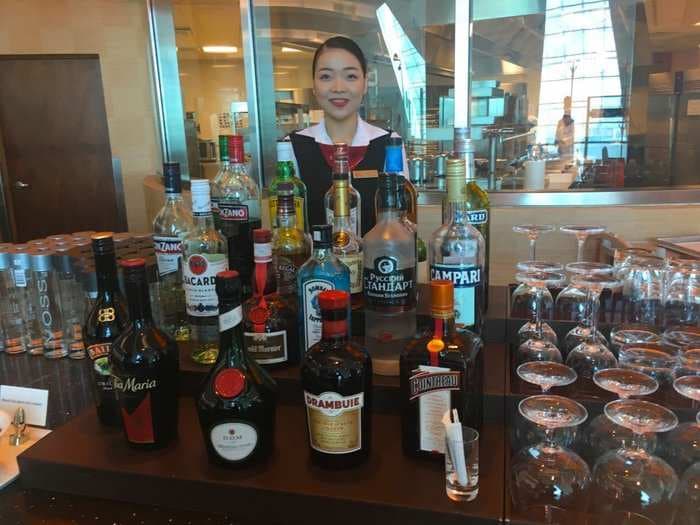 Emirates' business class lounge in Dubai has showers, beds, and a full bar - take a look inside
