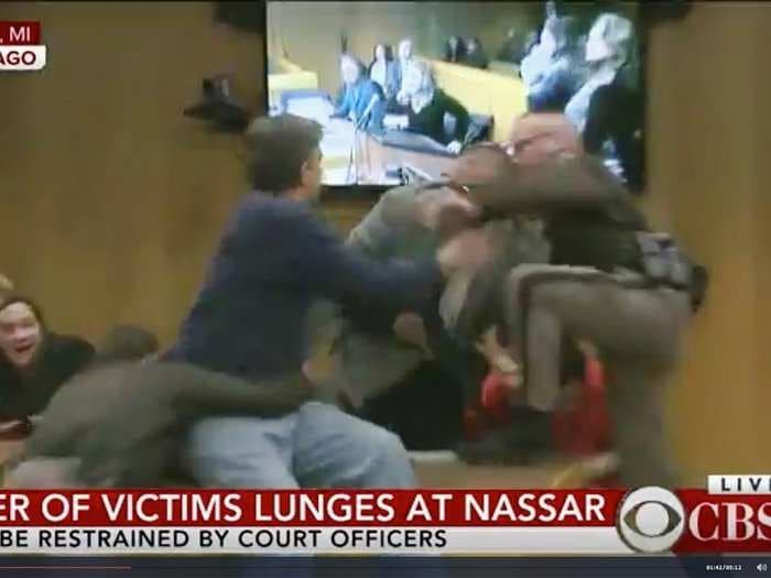 Man handcuffed for trying to attack Larry Nassar in court room after daughters said they were sexually abused by the disgraced doctor