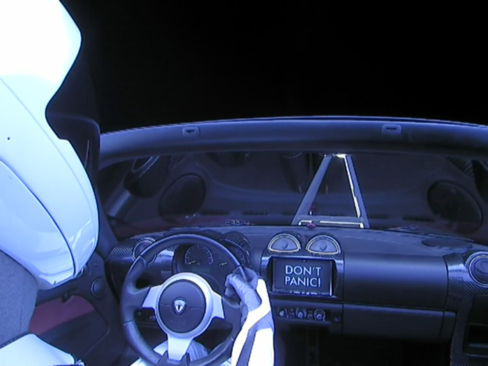 Here's why it says 'Don't Panic' on the dashboard of the car Elon Musk just shot toward Mars