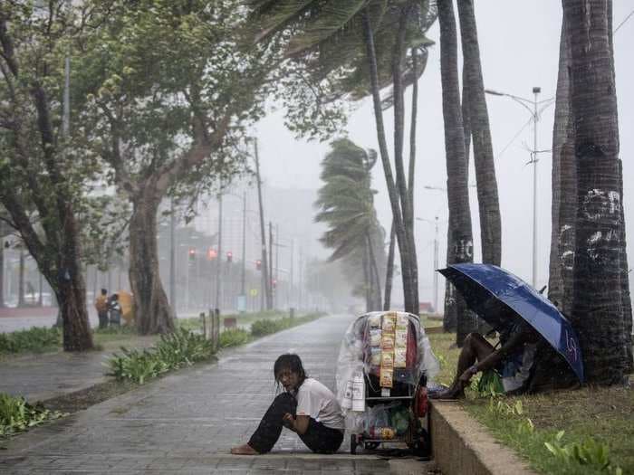 At least 6 are dead and dozens are trapped as a strong typhoon batters the Philippines