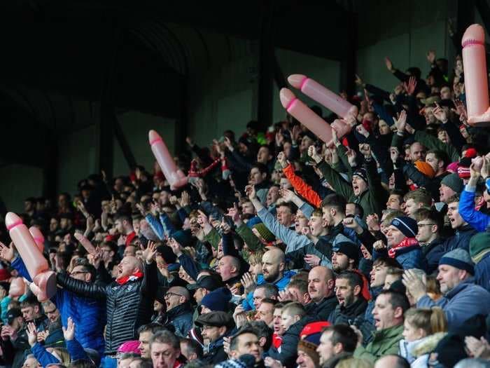 English soccer fans waved inflatable penises at a match to mock a club owner for tweeting a naked photo