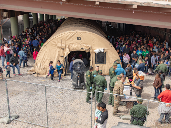 Photos show migrants being held in a makeshift facility under a bridge as Trump threatens to close the border entirely