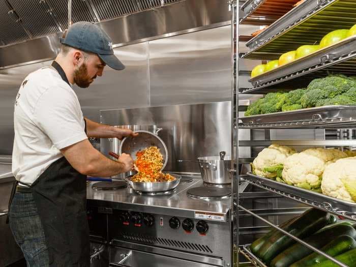 Petco is opening upscale kitchens in its stores where chefs will prepare human-grade meals for dogs - take a look inside