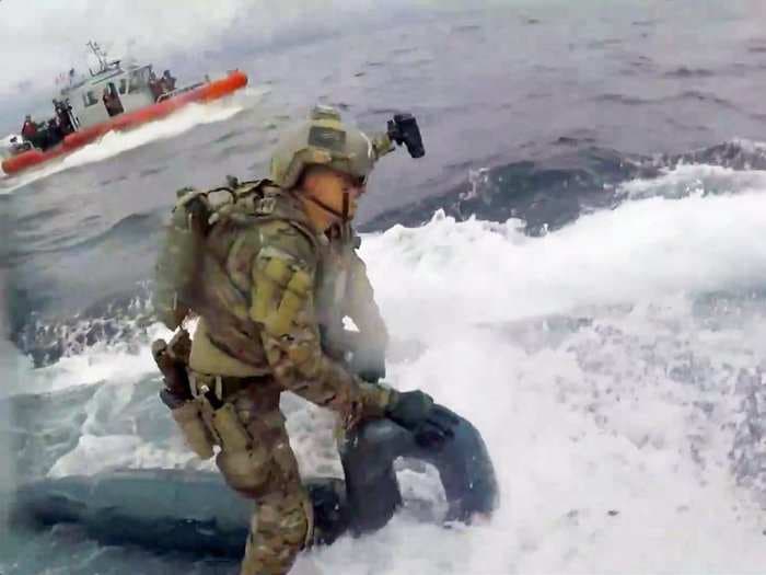 Heart-pounding video shows a badass Coast Guardsman running down a narco-sub loaded with cocaine and pounding on the hatch