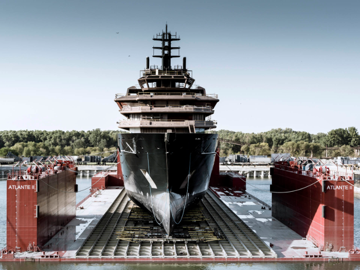 A sleek, black yacht that just launched is now the world's largest superyacht. Take a look at the 600-foot vessel that's owned by a Norwegian billionaire.