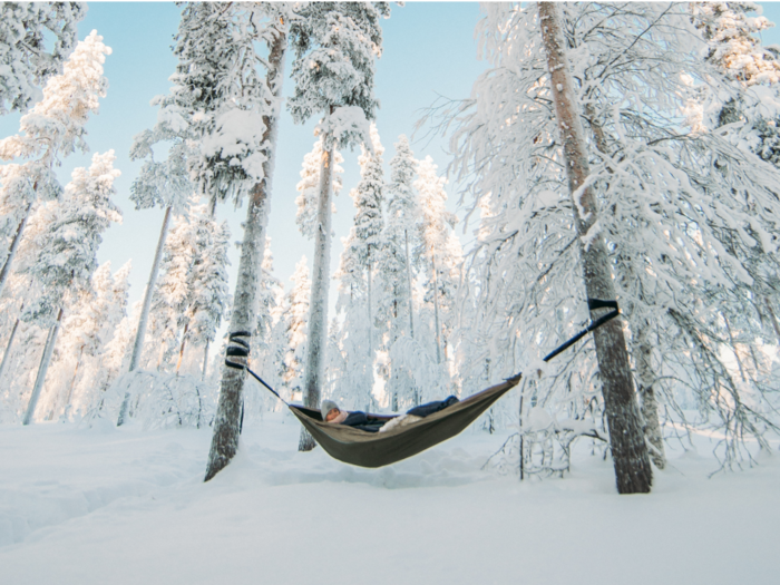 A Finnish family is offering a wellness experience called 'Arctic cocooning' where they tuck customers into hammocks in a remote pine forest in the winter. Here's what it's like.