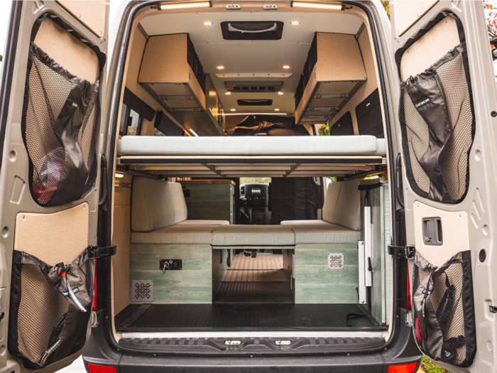 This custom tiny home on wheels was built inside Mercedes-Benz Sprinter van and designed to be lightweight with cot beds - see inside