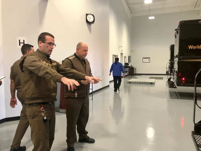 Inside a UPS training school where workers haul boxes across slick 'ice,' perform high-stakes driving drills, and deliver packages to empty homes in a mock neighborhood