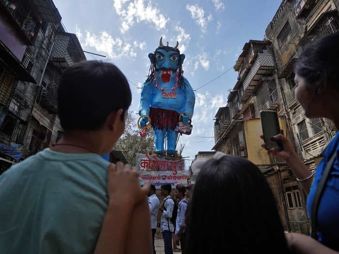 Residents in Mumbai, India, burned an effigy depicting the coronavirus as a big, blue demon during Holi celebrations